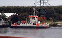 The canal crossing ferry with tractor onboard