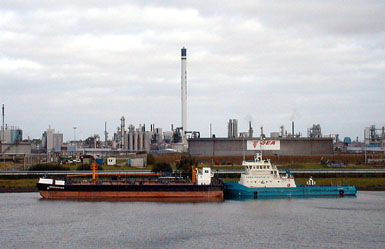 Ships alongside a refinery in the canal